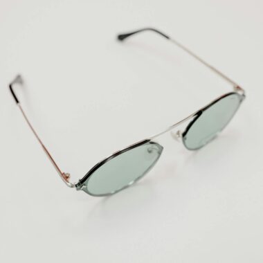 From above of contemporary sunglasses with lenses placed on white table in optical shop