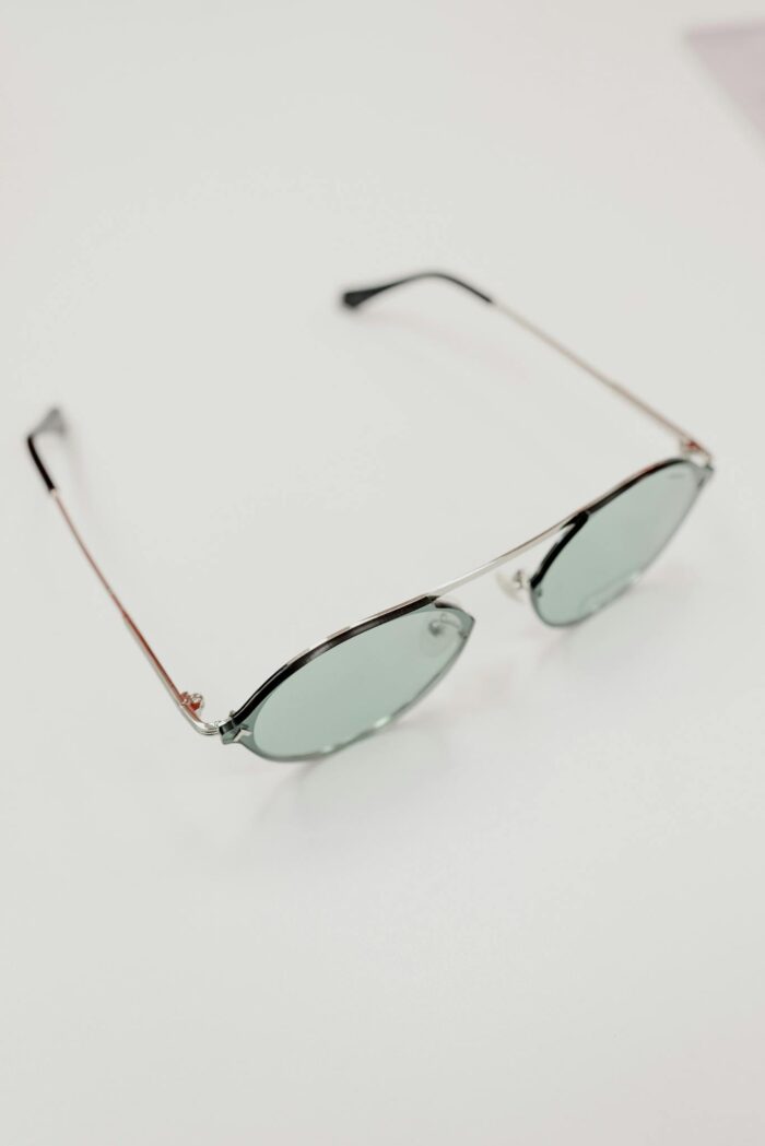 From above of contemporary sunglasses with lenses placed on white table in optical shop